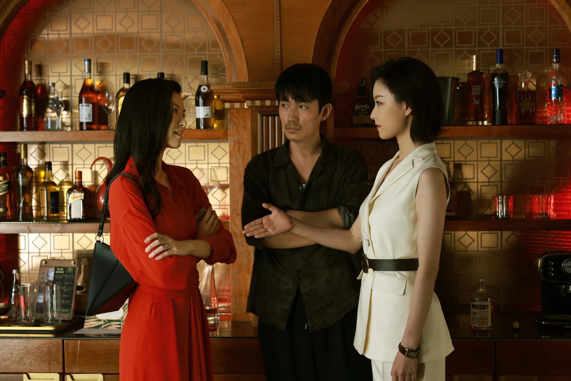 《消失的她》剧照：何非站在酒吧里，文咏珊与倪妮饰演的女子分站两侧。